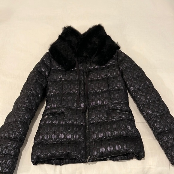 Black Moncler puffer jacket with detachable fur collar.